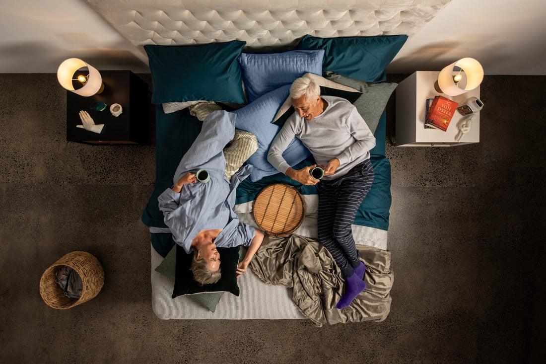 Two elderly people relaxing on a SleepMaker mattress