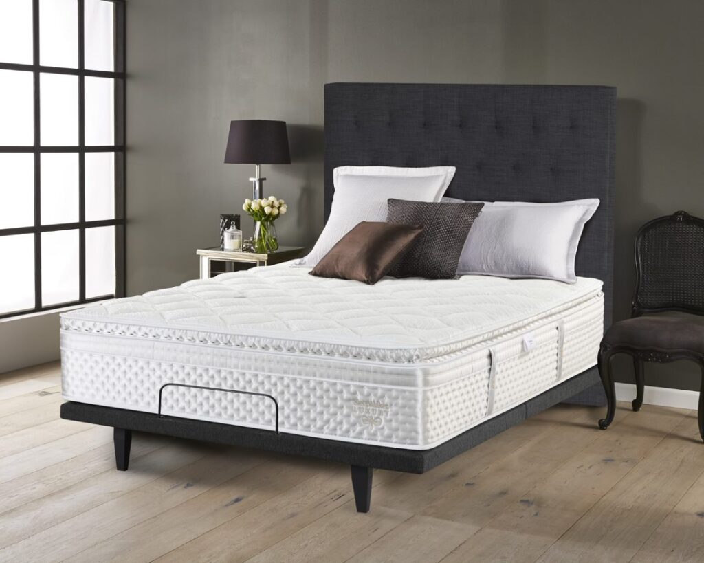 A SleepMaker mattress on an adjustable bed base in a bedroom
