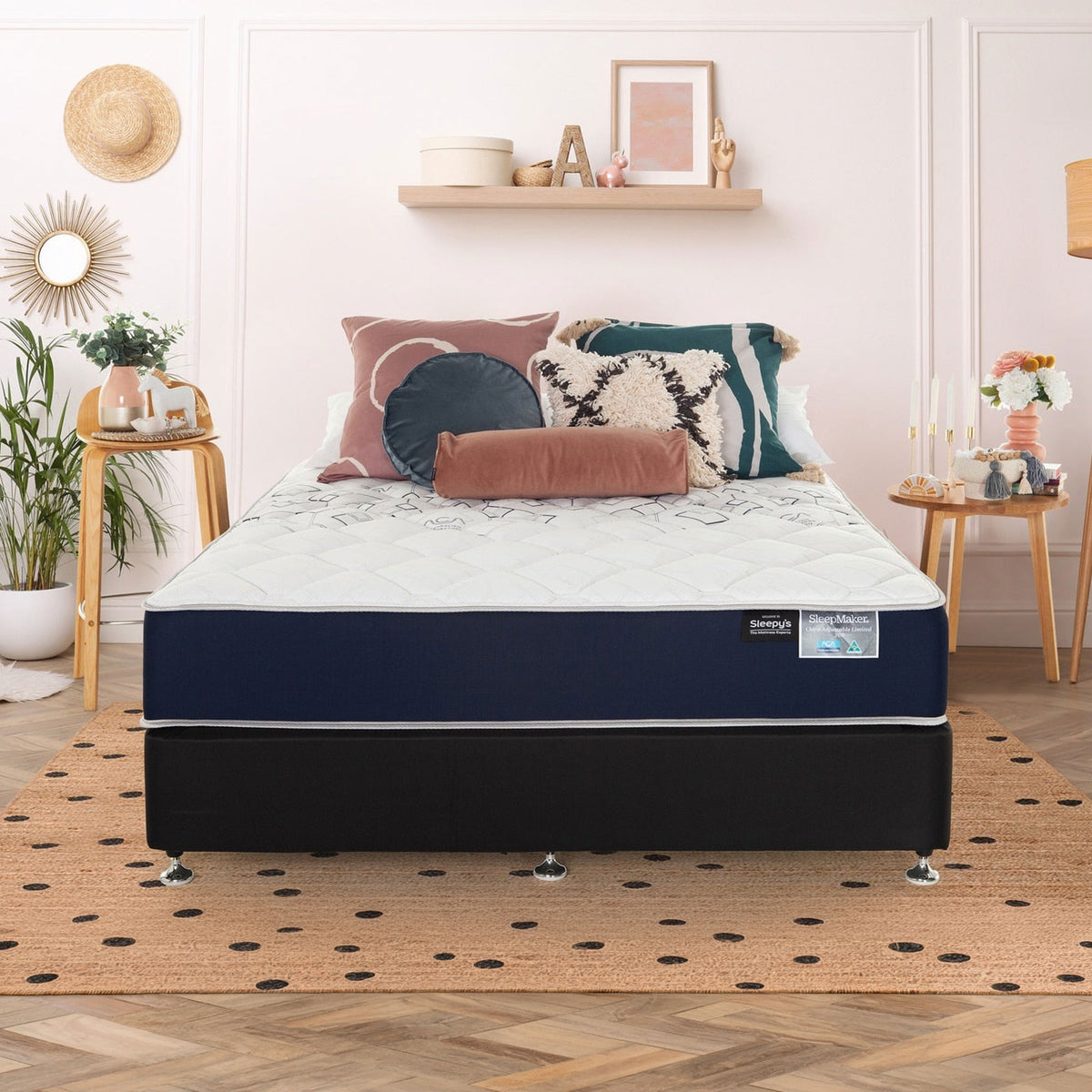 SleepMaker ACA mattress with blankets and pillows in a bedroom setting