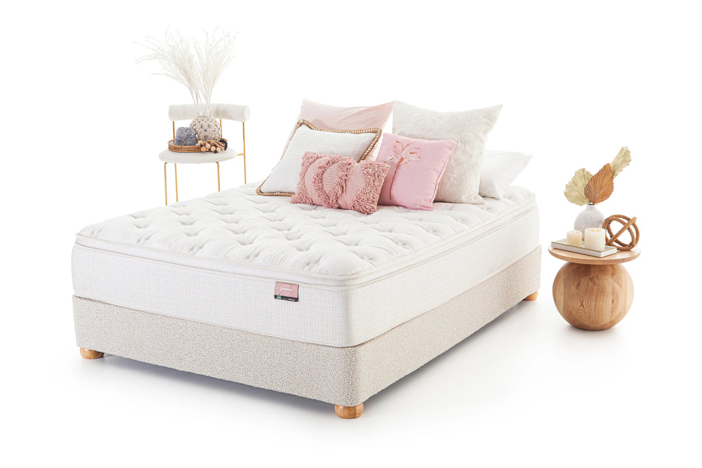 SleepMaker Bespoke mattress with pillows and furniture on a white background