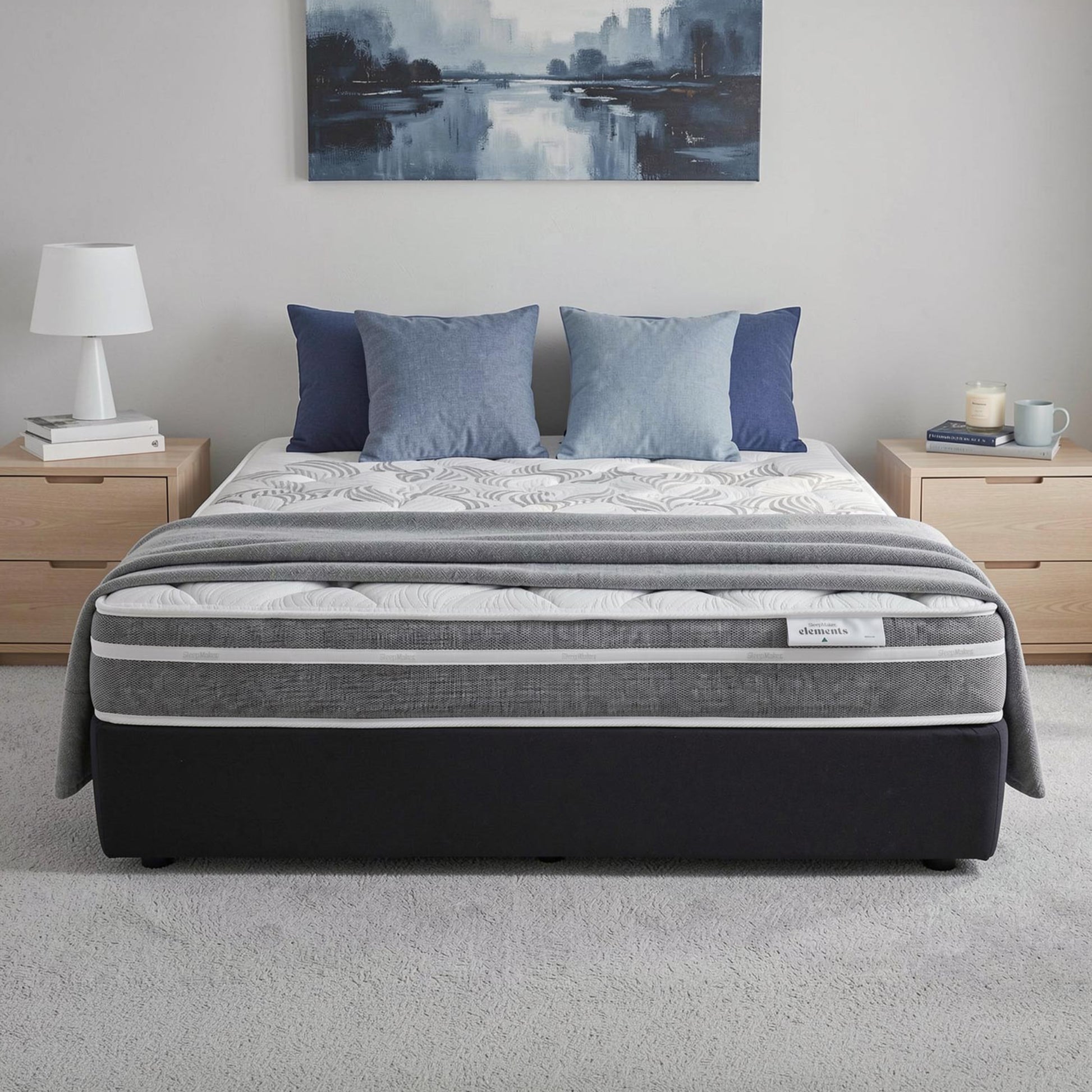SleepMaker Elements mattress with blankets and pillows in a bedroom setting