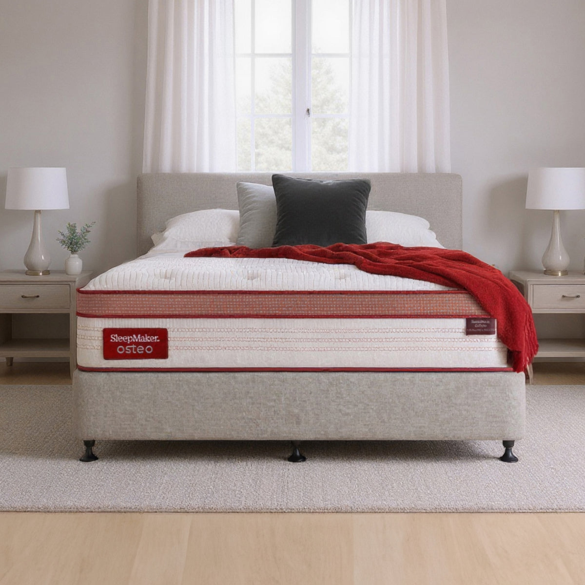 SleepMaker Osteo mattress with blankets and pillows in a bedroom setting
