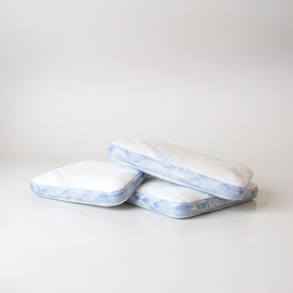 SleepMaker Advanced Collection pillows stacked on a light gray background