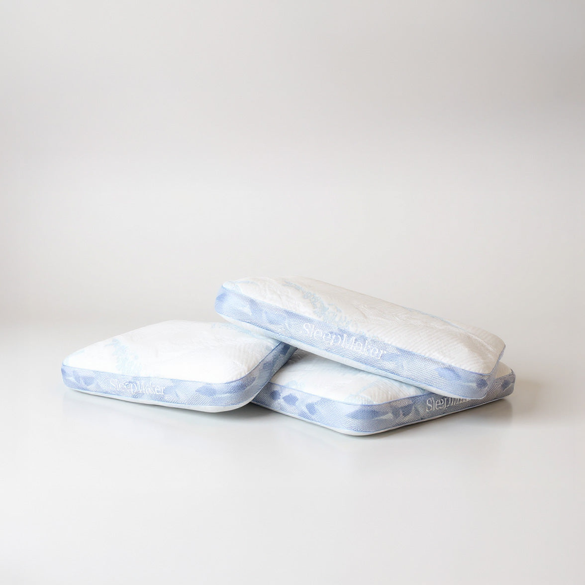 SleepMaker Advanced Collection pillows stacked on a light gray background
