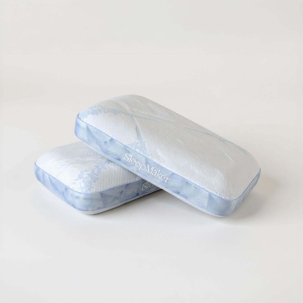 SleepMaker Advanced Collection pillows stacked on a light gray background