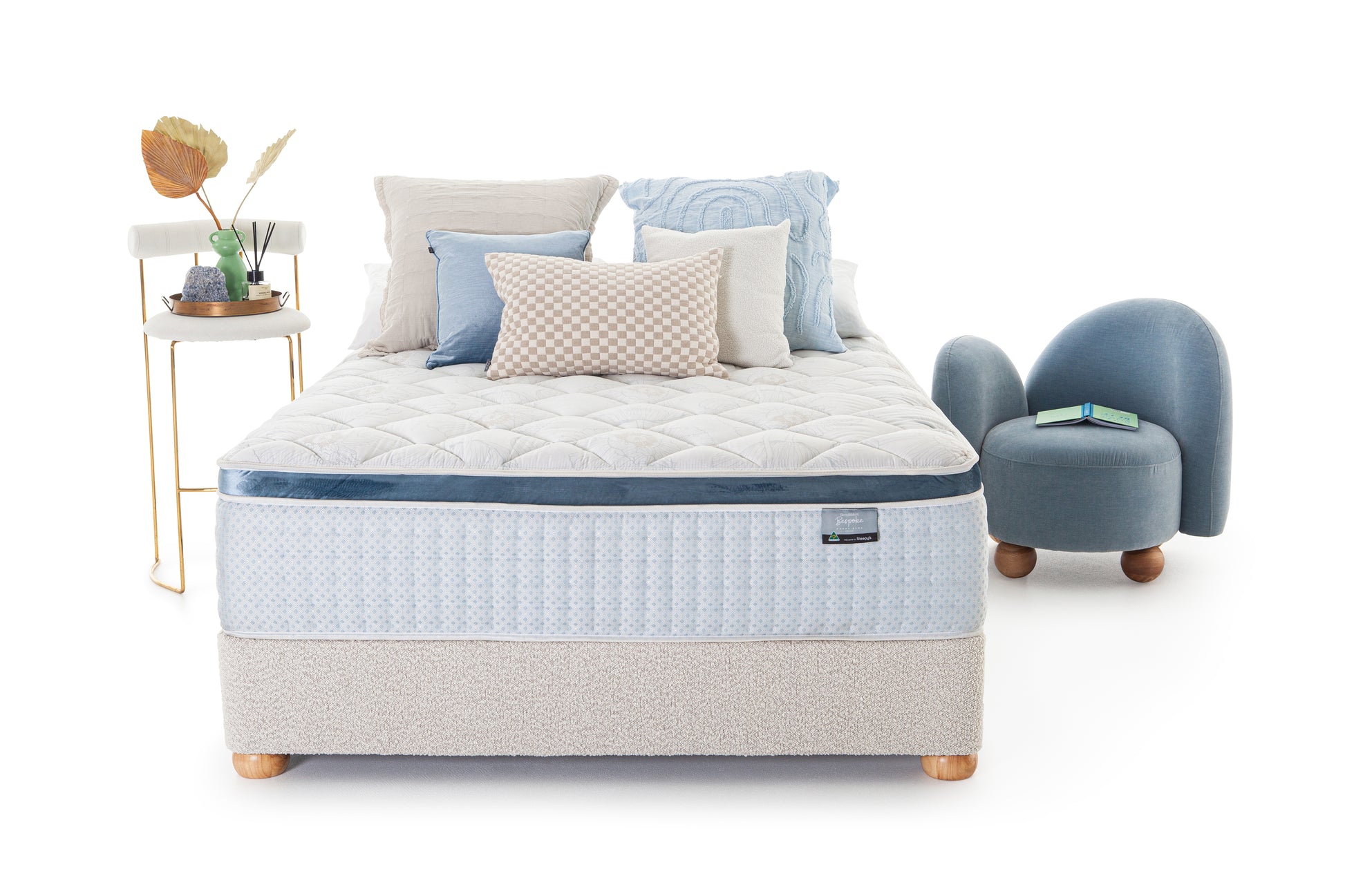 SleepMaker Bespoke mattress with pillows and furniture on a white background
