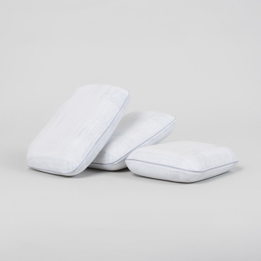 SleepMaker Comfort Collection pillows stacked on a light gray background