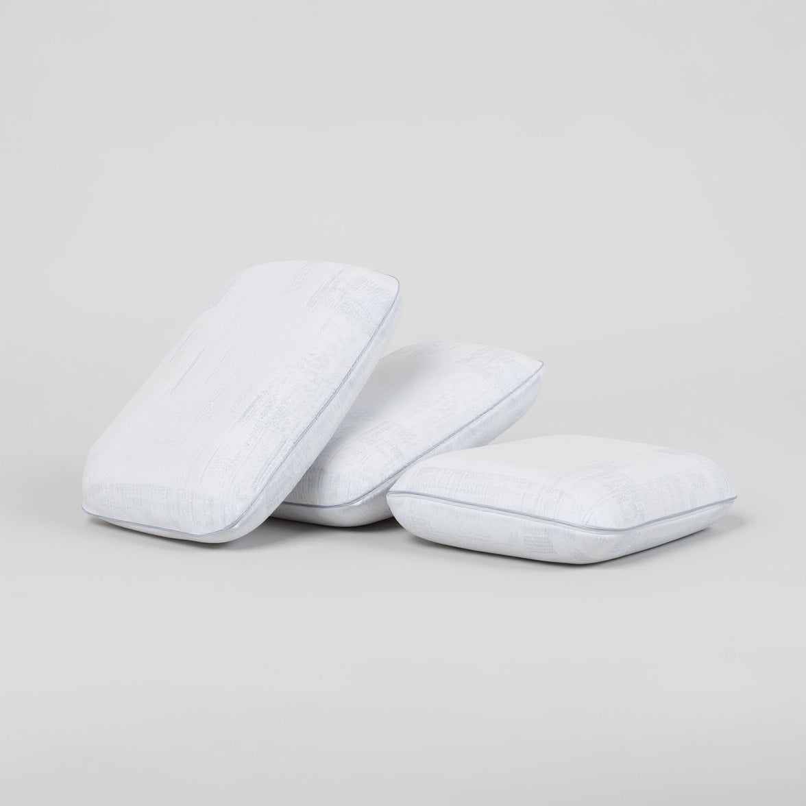 SleepMaker Comfort Collection pillows stacked on a light gray background