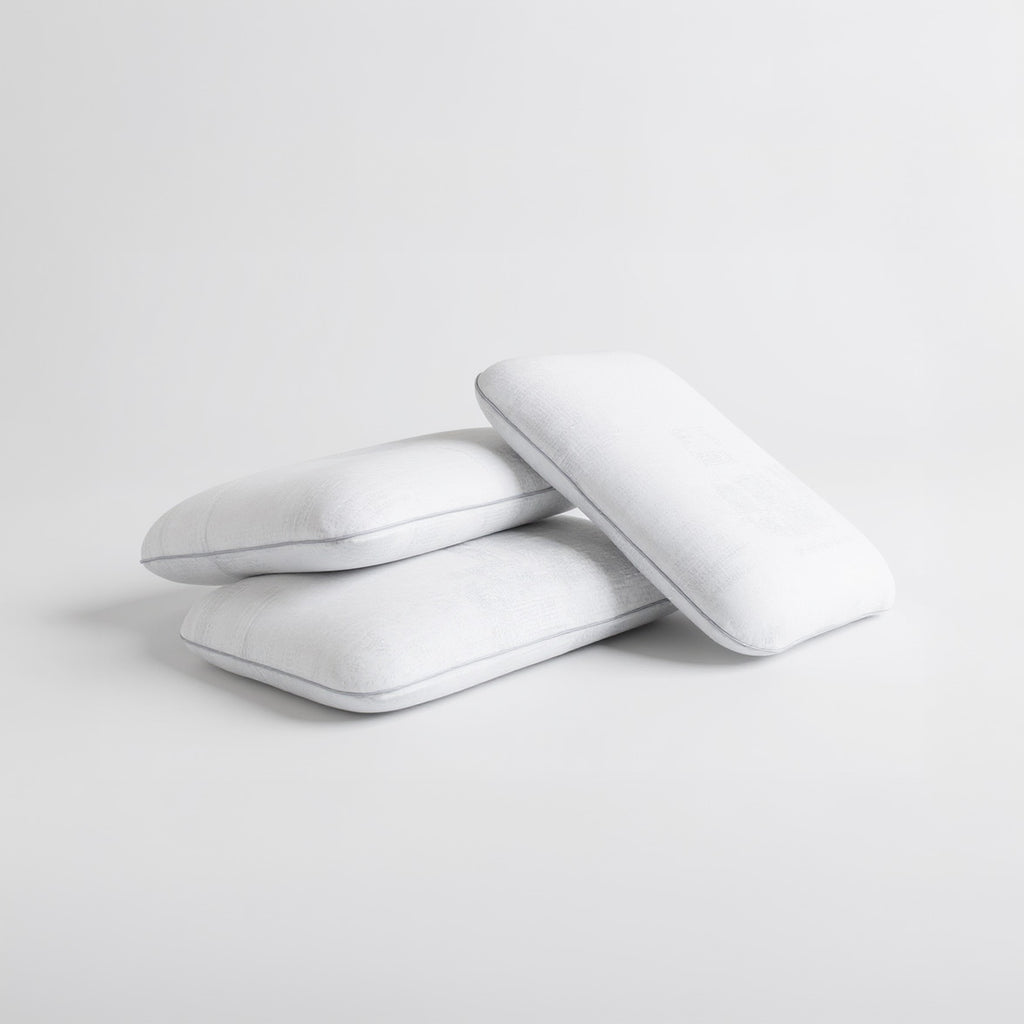 SleepMaker Comfort Collection pillows stacked on a light gray background