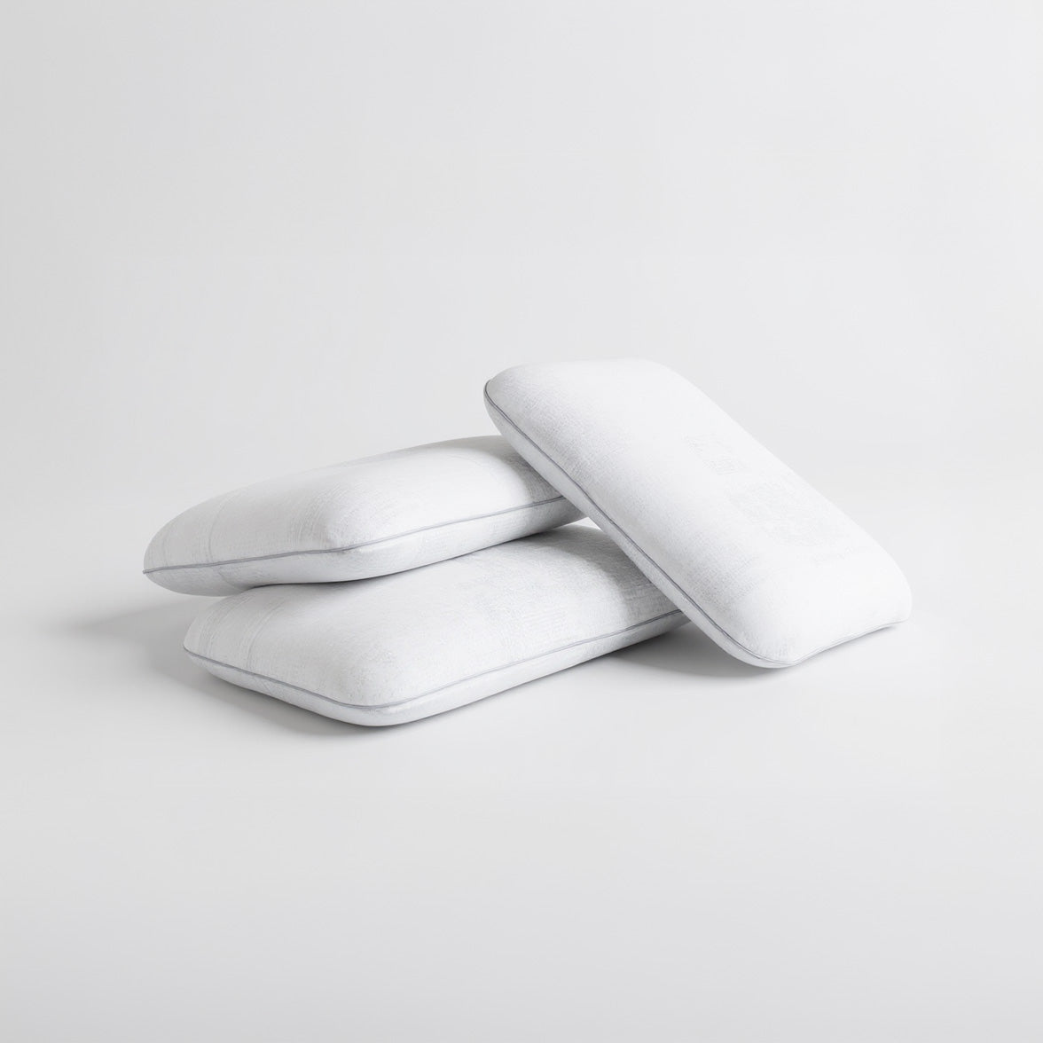 SleepMaker Comfort Collection pillows stacked on a light gray background