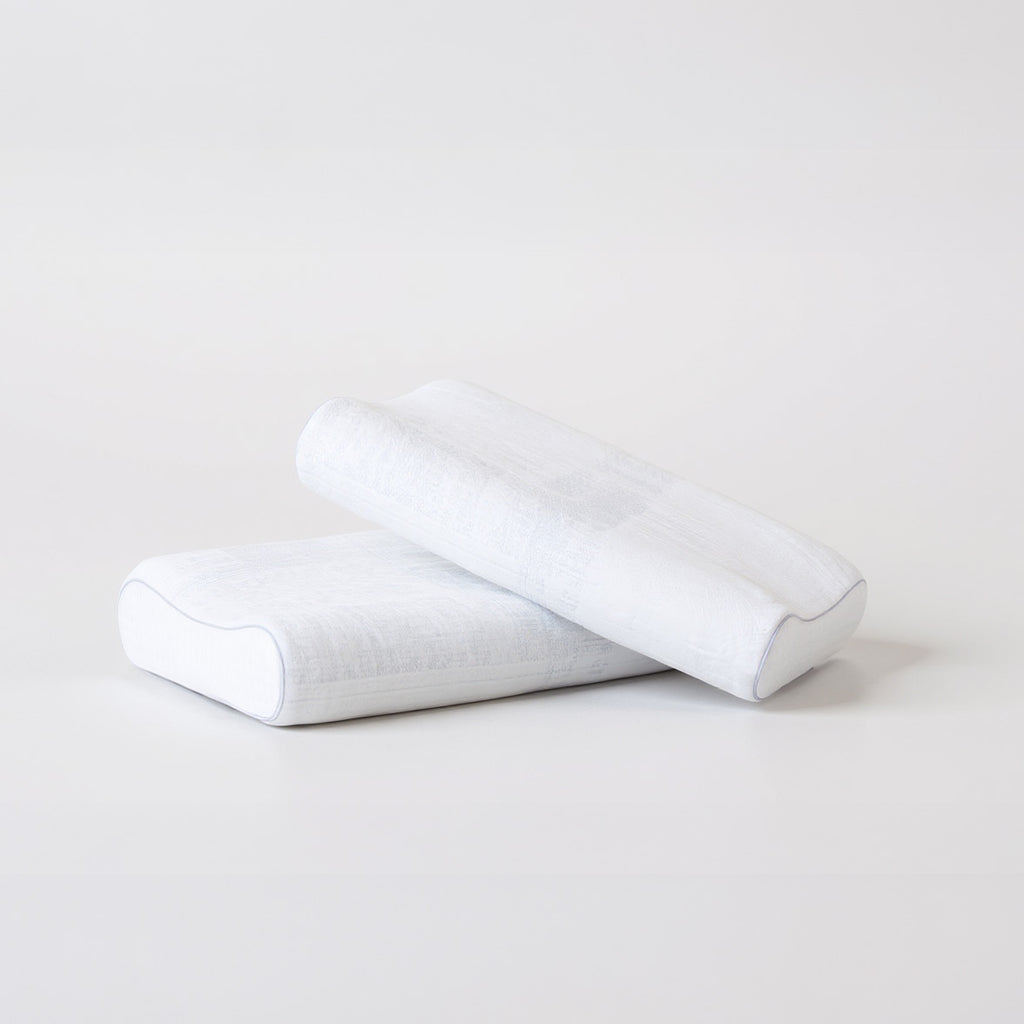 SleepMaker Comfort Collection pillows stacked on a light gray background