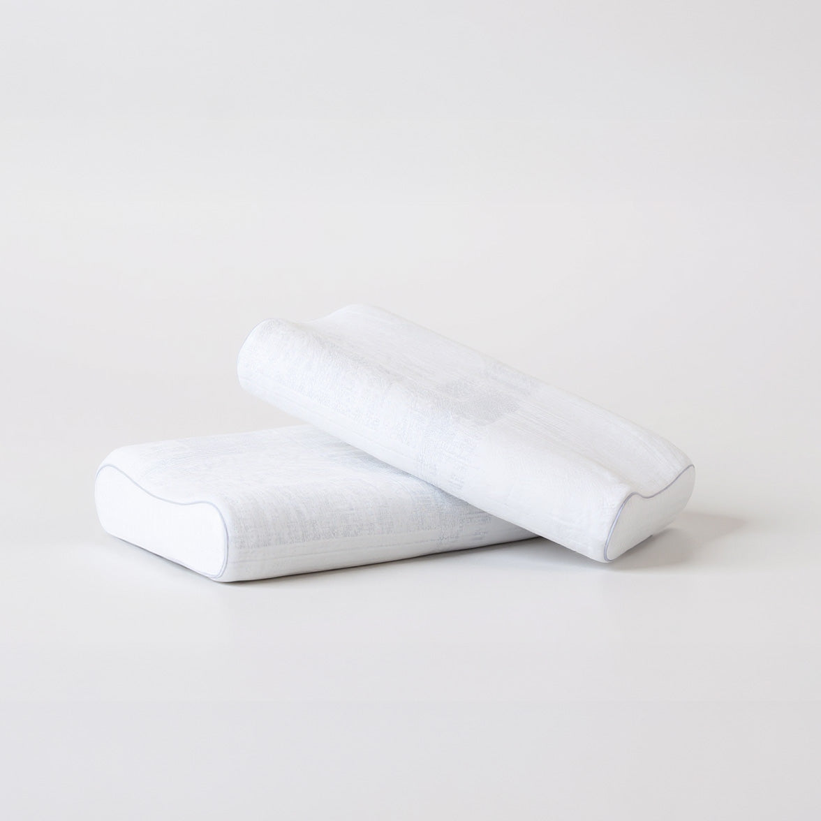 SleepMaker Comfort Collection pillows stacked on a light gray background