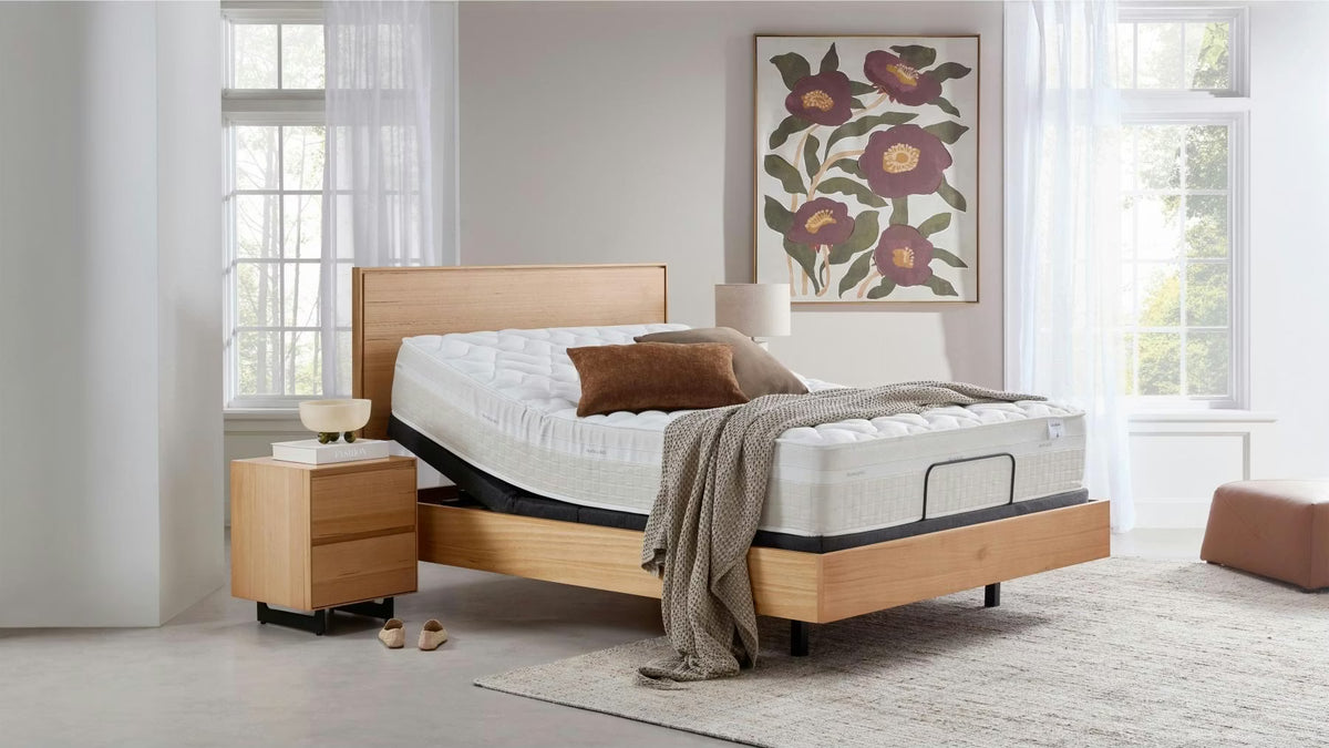 Dunlopillo by SleepMaker mattress sitting on an adjustable bed base in a bedroom setting