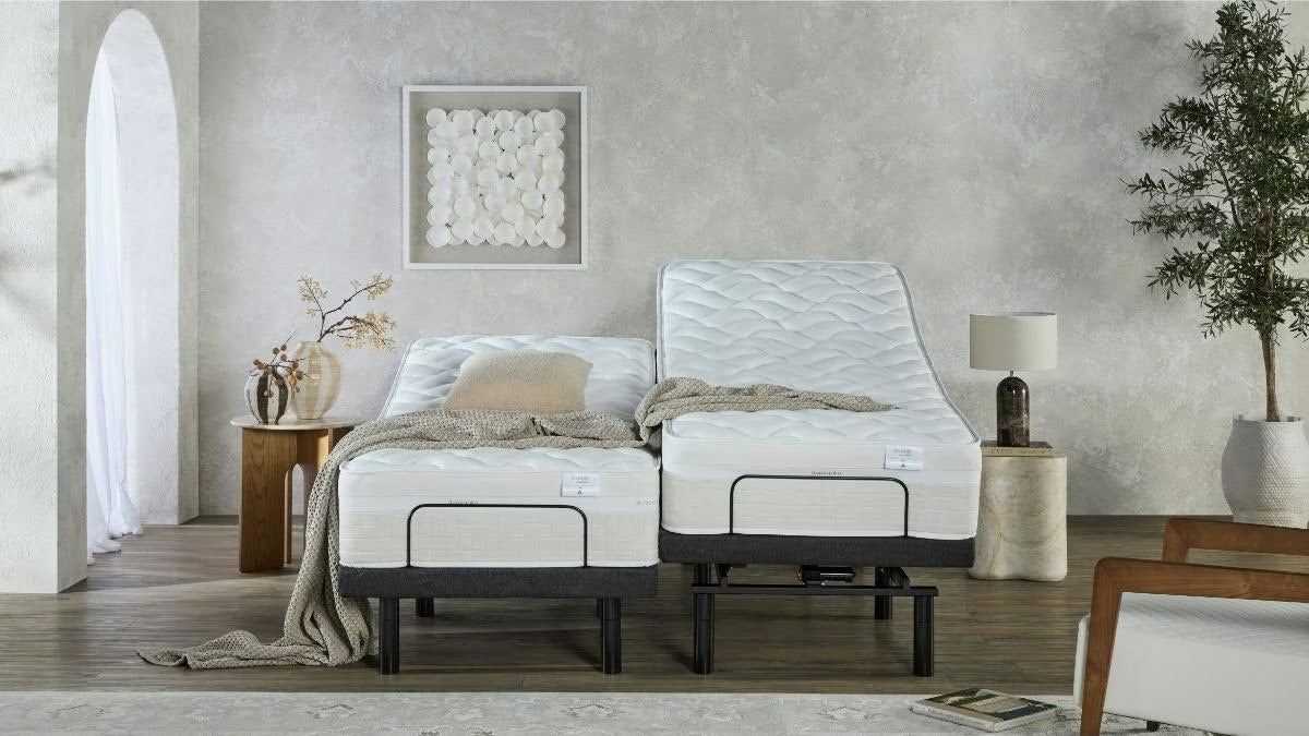 Two Dunlopillo by SleepMaker mattresses sitting on adjustable bed bases in a bedroom setting