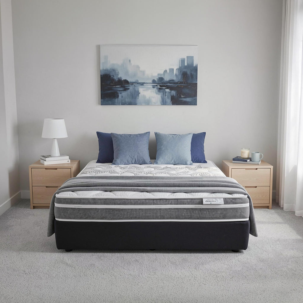 SleepMaker Elements mattress with blankets and pillows in a bedroom setting