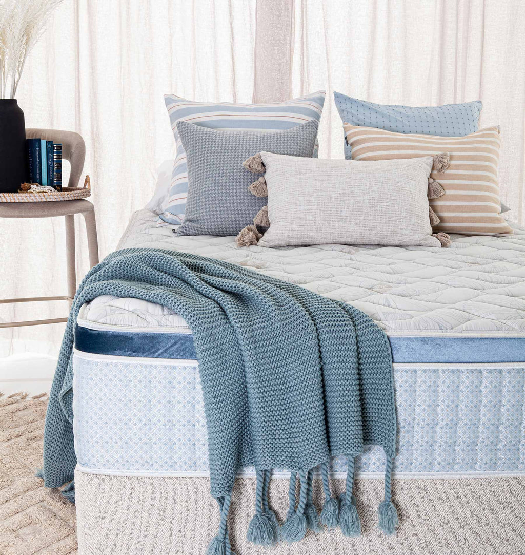 SleepMaker Bespoke mattress with pillows and furniture in a bedroom setting