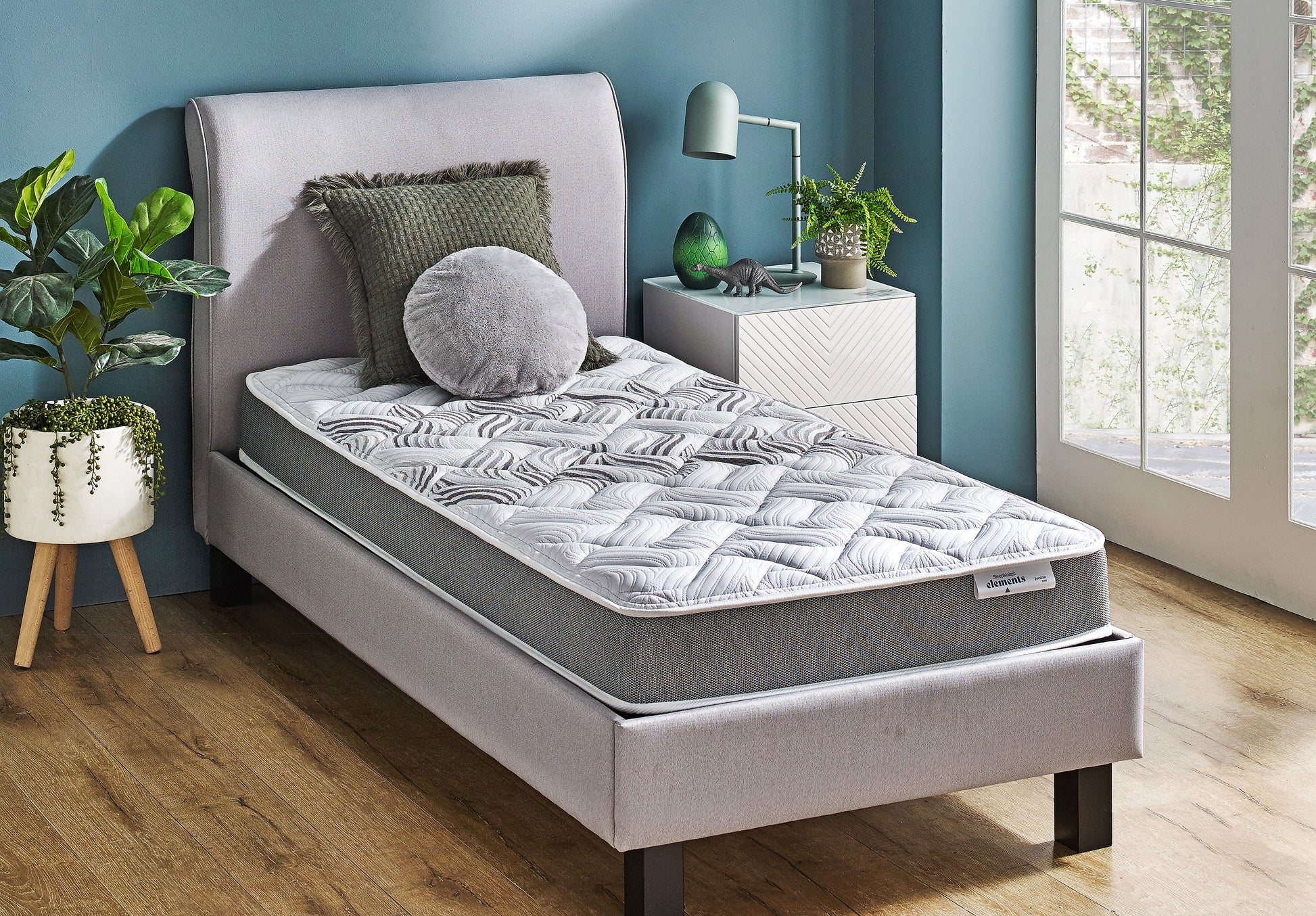 SleepMaker Elements mattress with blankets and pillows in a bedroom setting