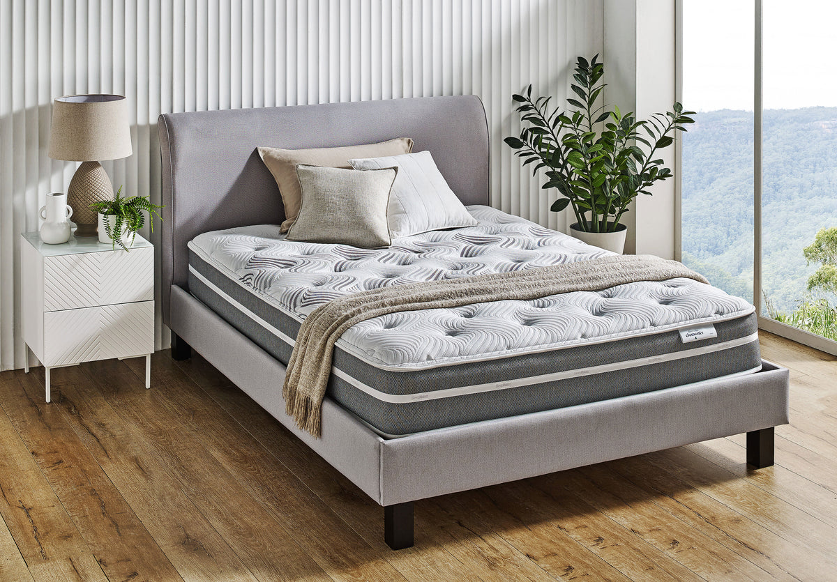SleepMaker Elements mattress with blankets and pillows in a bedroom setting